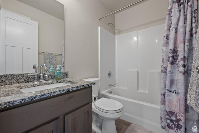 full bath featuring toilet, vanity, and shower / bathtub combination with curtain