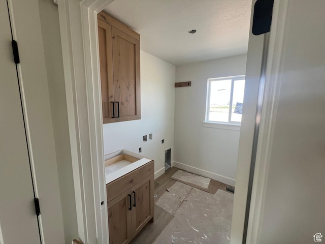 1155 E 1150 S, Garland, UT 84312 - washroom featuring electric dryer hookup, baseboards, and cabinet space