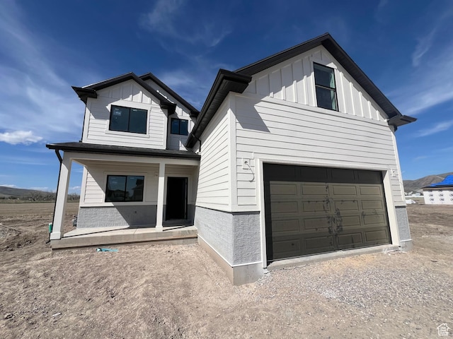 1155 E 1150 S, Garland, UT 84312 - view of front of property with a porch, driveway, board and batten siding, and a garage