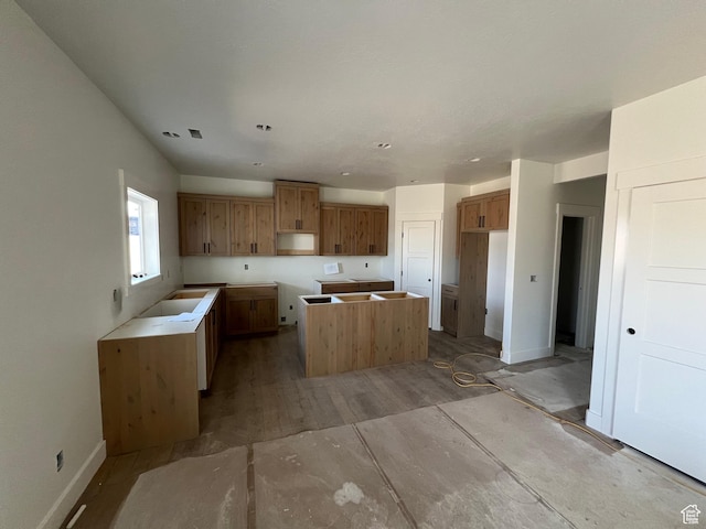 1155 E 1150 S, Garland, UT 84312 - kitchen with brown cabinetry, baseboards, a center island, and recessed lighting