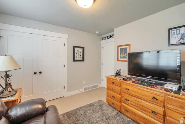 living room with carpet, visible vents, and baseboards