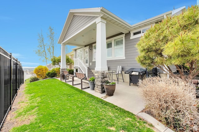 back of property featuring a lawn, a patio area, and a fenced backyard