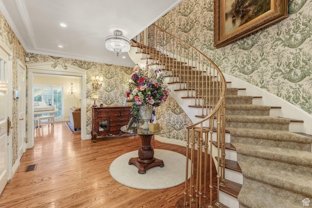1230 E 11th Ave N, Salt Lake City, UT 84103 - stairs with crown molding, wood finished floors, wallpapered walls, a notable chandelier, and visible vents