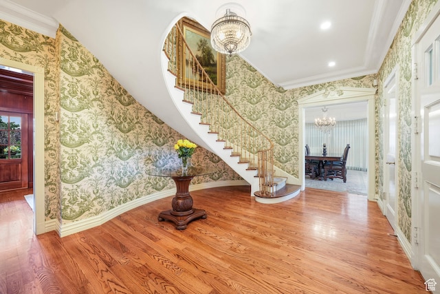 1230 E 11th Ave N, Salt Lake City, UT 84103 - entrance foyer featuring a chandelier, wallpapered walls, stairway, wood finished floors, and ornamental molding