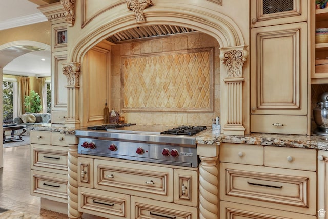 1230 E 11th Ave N, Salt Lake City, UT 84103 - kitchen with stainless steel gas stovetop, glass insert cabinets, arched walkways, ornamental molding, and light stone countertops
