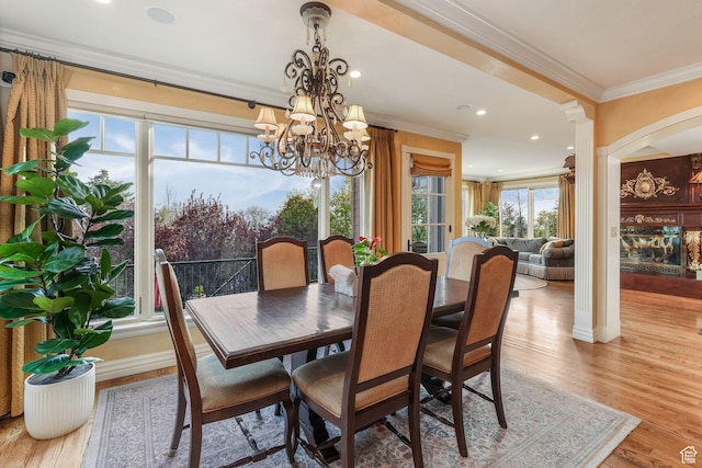 1230 E 11th Ave N, Salt Lake City, UT 84103 - dining area featuring light wood-style floors, crown molding, ornate columns, and a notable chandelier
