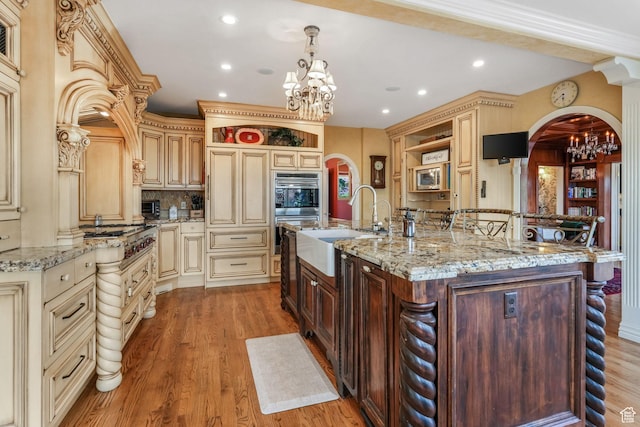 1230 E 11th Ave N, Salt Lake City, UT 84103 - kitchen featuring open shelves, a sink, arched walkways, a chandelier, and cream cabinets