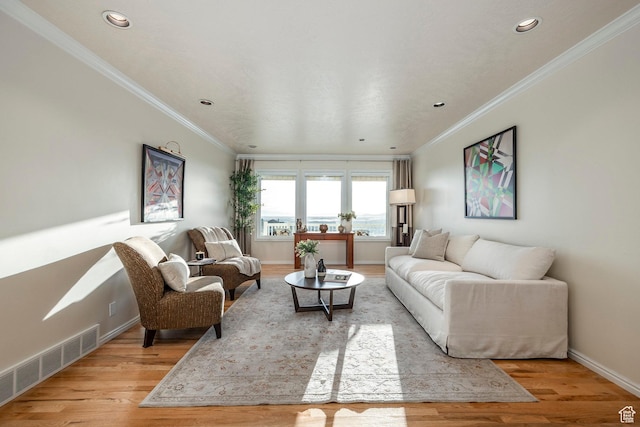 living room featuring light wood-type flooring, visible vents, crown molding, and baseboards