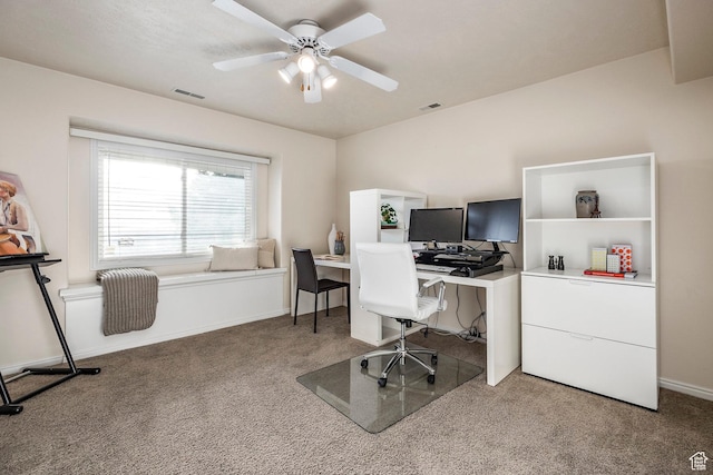 carpeted office space with baseboards, a ceiling fan, and visible vents