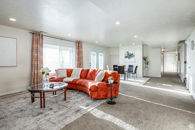 carpeted living area with baseboards, visible vents, and recessed lighting