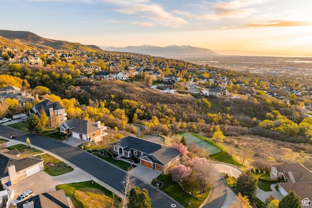 aerial view at dusk featuring a residential view and a mountain view