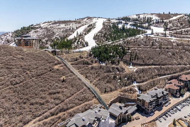 snowy aerial view with a mountain view