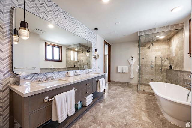 bathroom with a soaking tub, a sink, and a shower stall
