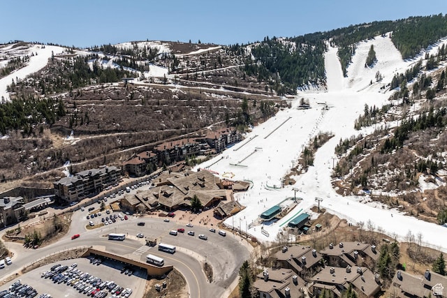 snowy aerial view featuring a mountain view