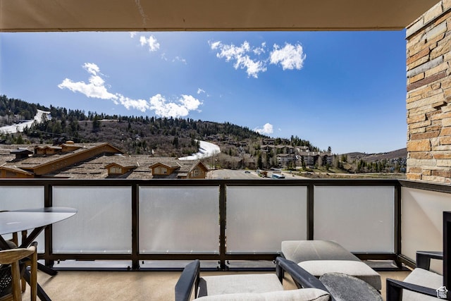 balcony with outdoor dining space and a mountain view