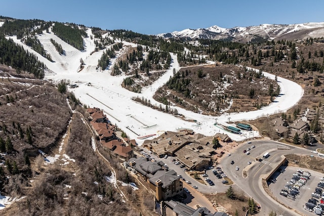 snowy aerial view featuring a mountain view