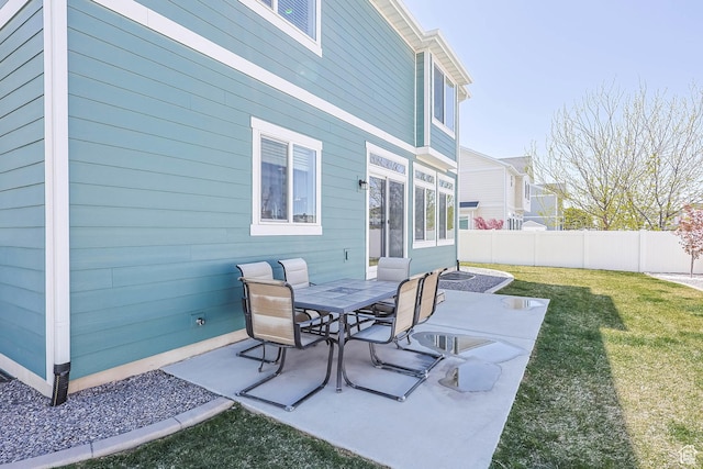view of patio featuring outdoor dining area and fence