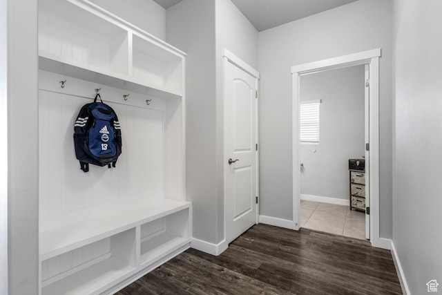 mudroom with baseboards and dark wood-style flooring