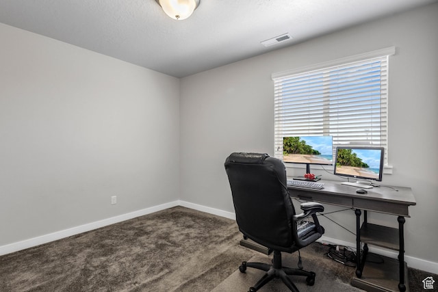 carpeted home office featuring visible vents and baseboards