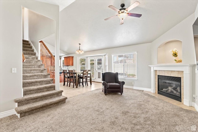 7134 S Rialto Way, West Jordan, UT 84081 - living area with stairs, lofted ceiling, ceiling fan, a tile fireplace, and light carpet