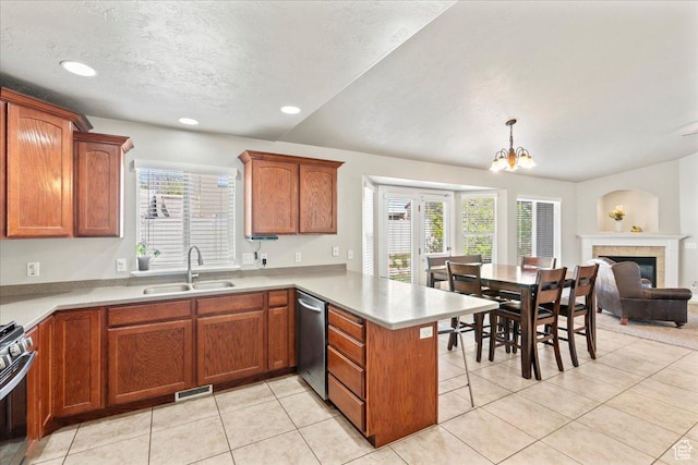 7134 S Rialto Way, West Jordan, UT 84081 - kitchen with a sink, a peninsula, stainless steel appliances, light countertops, and a textured ceiling