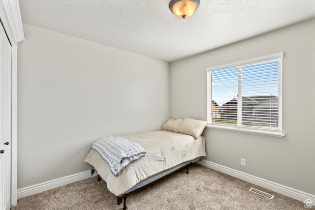 7134 S Rialto Way, West Jordan, UT 84081 - bedroom with carpet floors, baseboards, a closet, and a textured ceiling