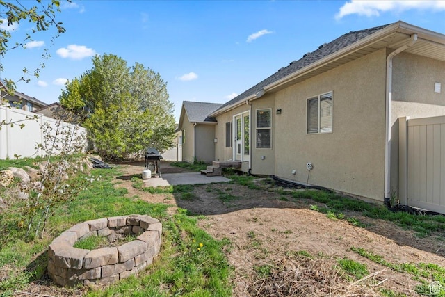 7134 S Rialto Way, West Jordan, UT 84081 - view of yard with a patio, an outdoor fire pit, and fence