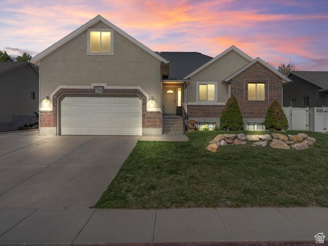 7134 S Rialto Way, West Jordan, UT 84081 - traditional-style house with driveway, brick siding, stucco siding, an attached garage, and a gate