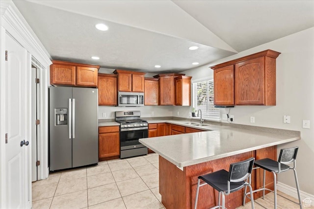 7134 S Rialto Way, West Jordan, UT 84081 - kitchen with appliances with stainless steel finishes, a sink, a peninsula, brown cabinets, and recessed lighting