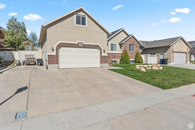 7134 S Rialto Way, West Jordan, UT 84081 - traditional-style house featuring concrete driveway, stucco siding, a gate, brick siding, and a garage