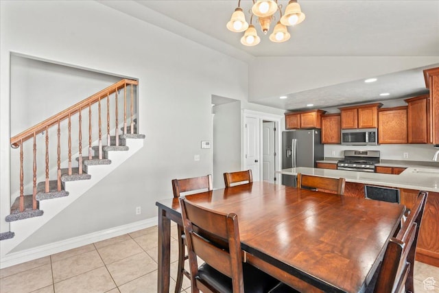7134 S Rialto Way, West Jordan, UT 84081 - dining space with lofted ceiling, a chandelier, stairs, baseboards, and light tile patterned flooring