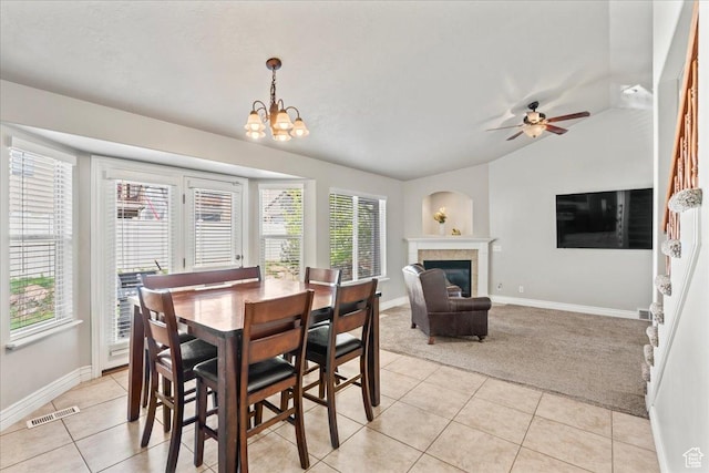 7134 S Rialto Way, West Jordan, UT 84081 - dining room featuring light colored carpet, light tile patterned flooring, lofted ceiling, a fireplace, and baseboards