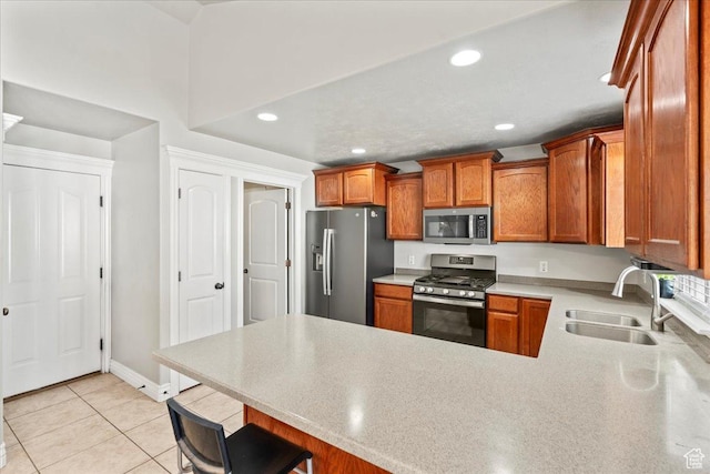 7134 S Rialto Way, West Jordan, UT 84081 - kitchen featuring appliances with stainless steel finishes, a sink, a peninsula, light countertops, and recessed lighting
