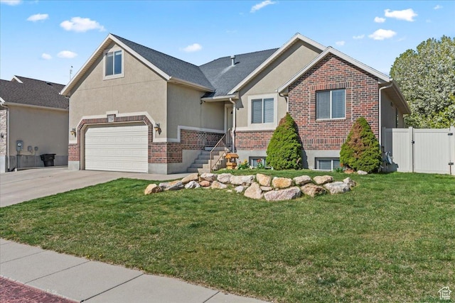 7134 S Rialto Way, West Jordan, UT 84081 - view of front facade featuring driveway, stucco siding, brick siding, and a gate