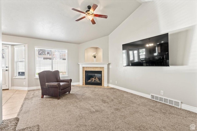 7134 S Rialto Way, West Jordan, UT 84081 - carpeted living area featuring lofted ceiling, a tile fireplace, ceiling fan, healthy amount of natural light, and baseboards