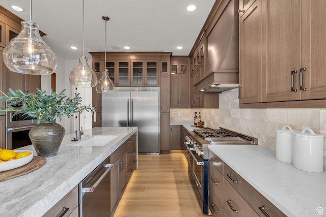 1338 S 1220 E, Salem, UT 84653 - kitchen with custom exhaust hood, high quality appliances, a sink, hanging light fixtures, and light wood-style flooring