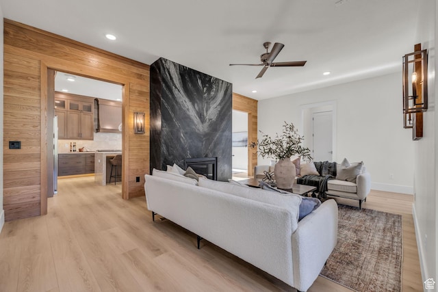 1338 S 1220 E, Salem, UT 84653 - living area with light wood-style floors, wooden walls, ceiling fan, a large fireplace, and recessed lighting