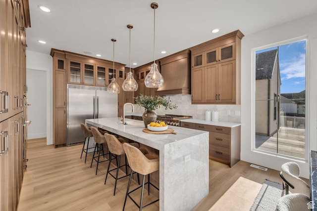 1338 S 1220 E, Salem, UT 84653 - kitchen with brown cabinetry, custom exhaust hood, stainless steel built in refrigerator, and light wood-style floors