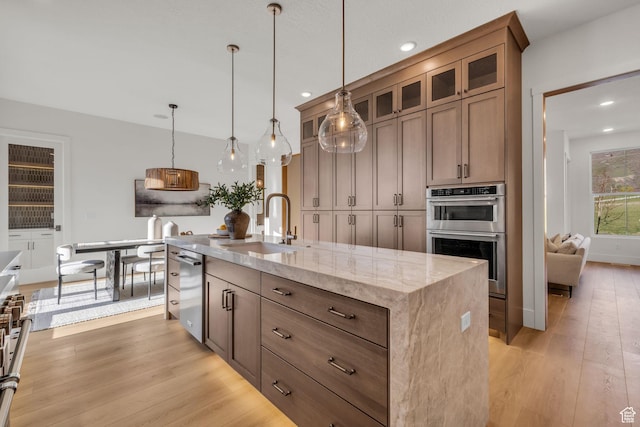 1338 S 1220 E, Salem, UT 84653 - kitchen with light wood finished floors, a sink, an island with sink, and appliances with stainless steel finishes