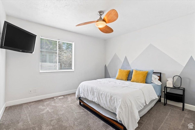 carpeted bedroom featuring visible vents, baseboards, and ceiling fan