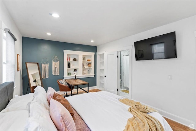 bedroom with baseboards, wood finished floors, and recessed lighting