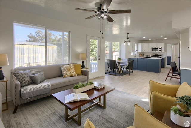 1166 E 4875 S, Ogden, UT 84403 - living area featuring recessed lighting, light wood-style floors, and ceiling fan with notable chandelier