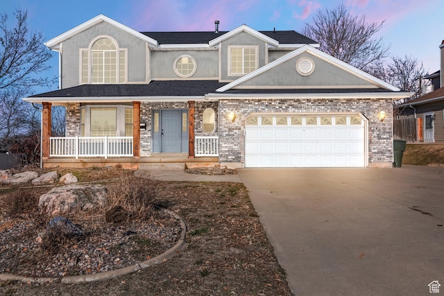 1166 E 4875 S, Ogden, UT 84403 - view of front of home featuring concrete driveway, stucco siding, a garage, and covered porch