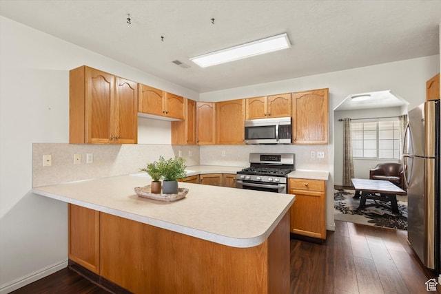 325 E 2300 N, North Ogden, UT 84414 - kitchen with stainless steel appliances, backsplash, a peninsula, dark wood-type flooring, and visible vents