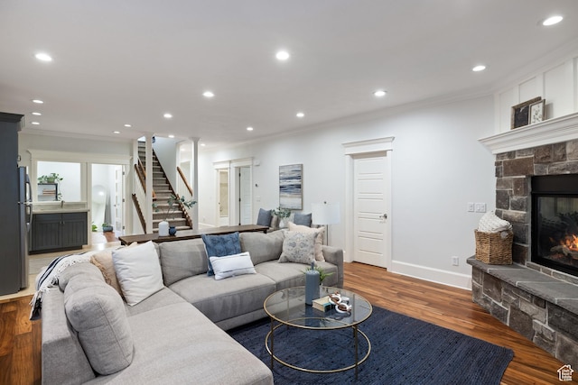 1263 E Chapman Ct, Alpine, UT 84004 - living room featuring crown molding, stairway, a stone fireplace, recessed lighting, and wood finished floors