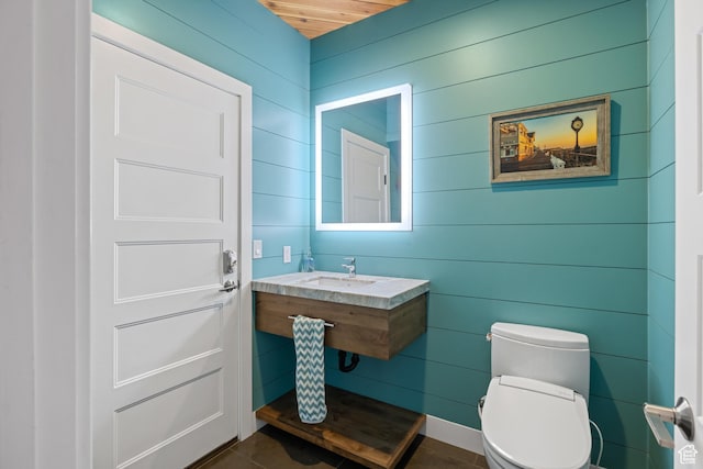 1263 E Chapman Ct, Alpine, UT 84004 - half bath featuring toilet, a sink, tile patterned floors, and wooden walls