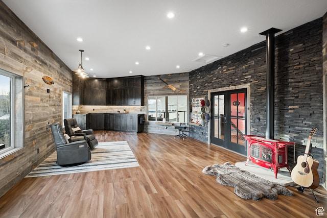 1263 E Chapman Ct, Alpine, UT 84004 - living area featuring a wood stove, plenty of natural light, wooden walls, light wood-type flooring, and recessed lighting