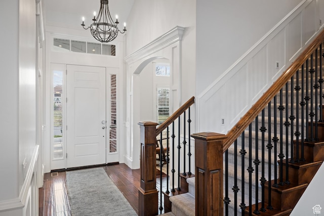 1263 E Chapman Ct, Alpine, UT 84004 - foyer entrance with a decorative wall, dark wood-style flooring, a chandelier, stairway, and arched walkways