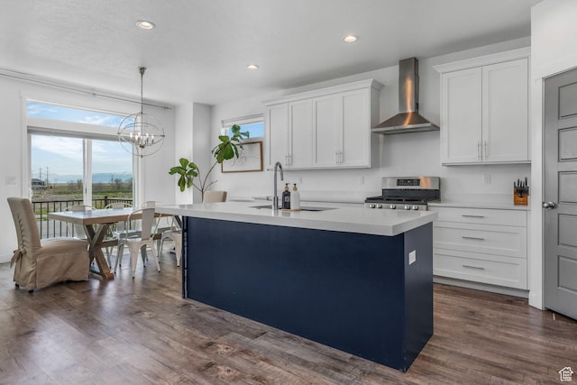 14 E 2300 S, Kaysville, UT 84037 - kitchen featuring wall chimney range hood, stainless steel range, a sink, light countertops, and an island with sink