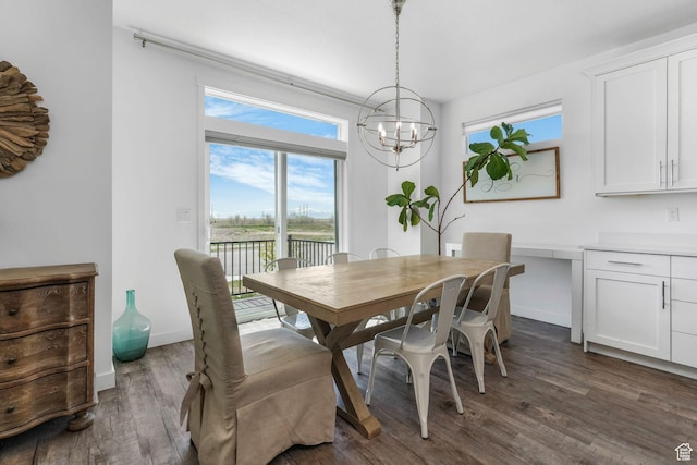 14 E 2300 S, Kaysville, UT 84037 - dining space featuring a chandelier, dark wood-style flooring, and baseboards